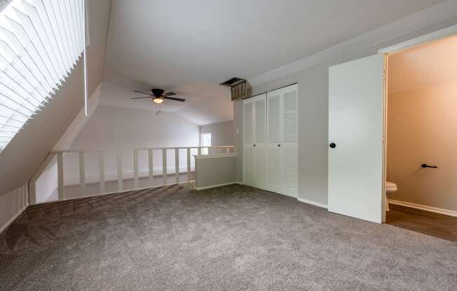 the upstairs bedroom has a closet and a ceiling fan