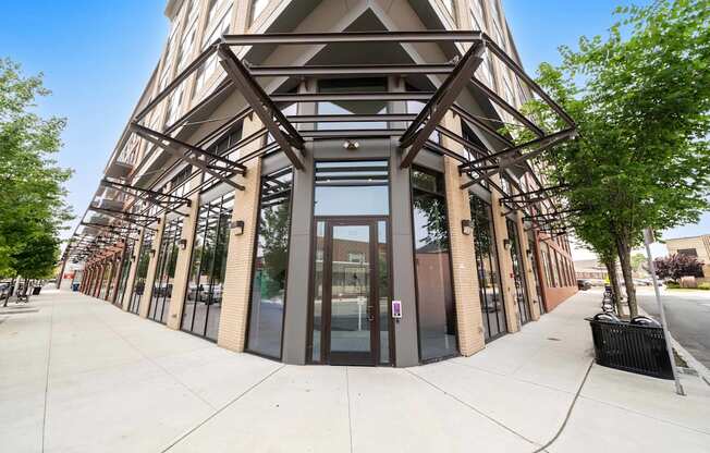 A building with a triangular facade and large glass windows.