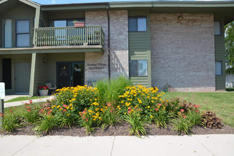 a house with a flower garden in front of it