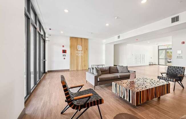 A modern living room with a wooden floor and furniture.