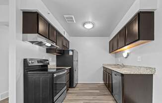 Upgraded Kitchen with stainless steel appliances and granite countertops at Westwood Village Apartments in Westland, MI
