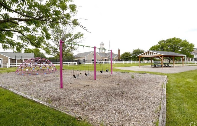 a playground and a picnic shelter in a park