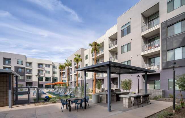 our apartments have a large patio with tables and chairs and a pool