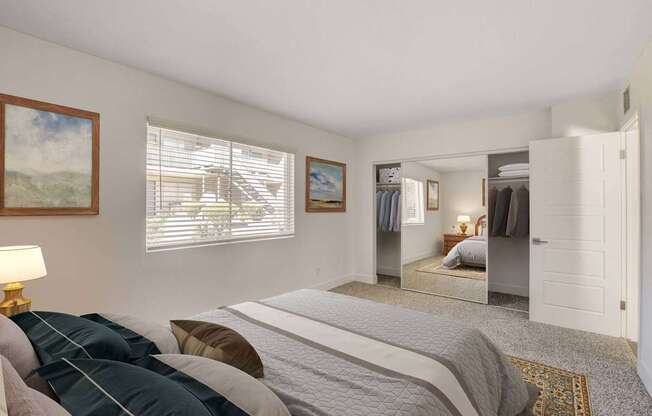 A bedroom with a large bed and a painting on the wall.