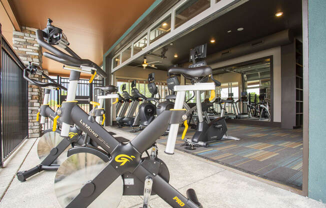 Cycling machines on Fitness Center patio, garage door opens space up