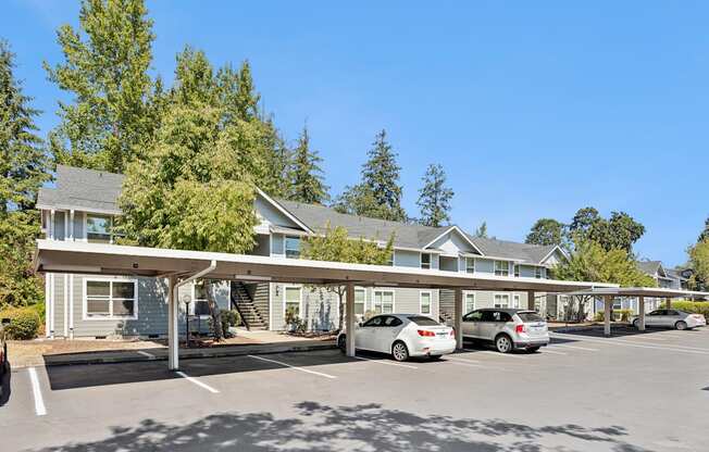 A parking lot with cars and a building in the background.