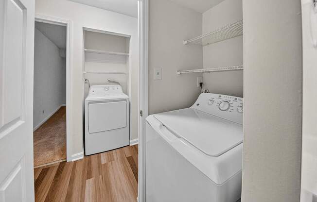 A small bedroom with a washer and dryer built into the cabinetry.