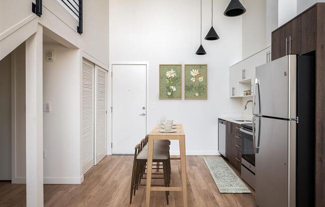 a kitchen with a wooden table and a refrigerator