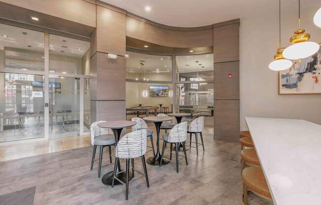 A modern dining area with a glass wall and a curved ceiling at Harbor Pointe Apartments, Bayonne, NJ, 07002