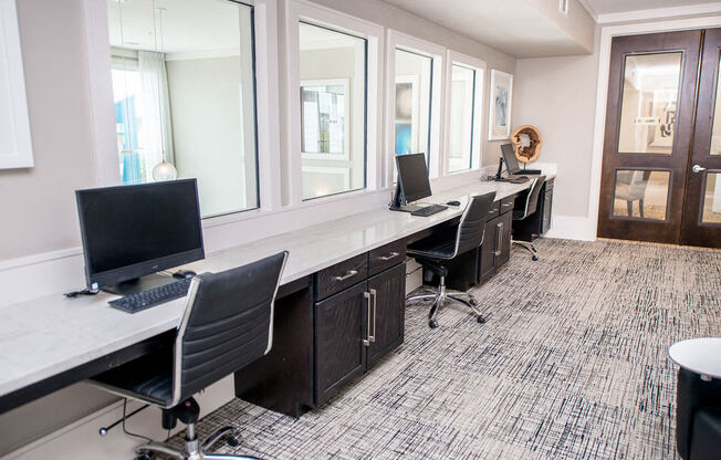 a large office with desks and chairs with computers