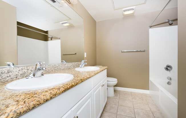 a bathroom with a toilet sink and shower