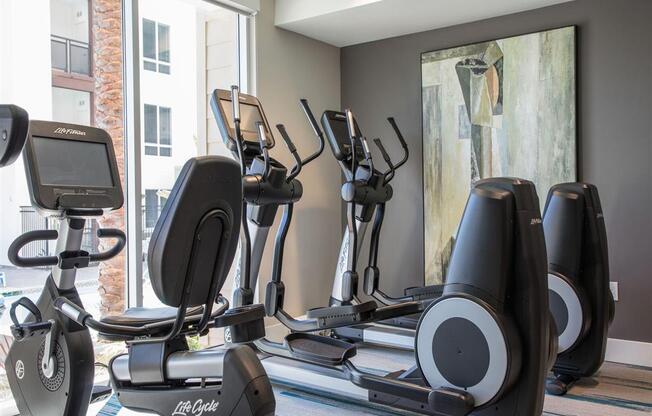 a gym with treadmills and elliptical machines