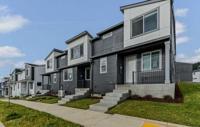Row of houses with a sidewalk in front at Thrive at Green Mountain, Washington  , 98607