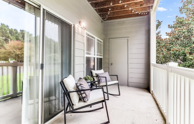 A patio with a table and chairs is shown, Plantation Crossing, Lafayette, LA, 70508