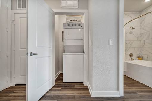 A white laundry room with a washer and dryer.