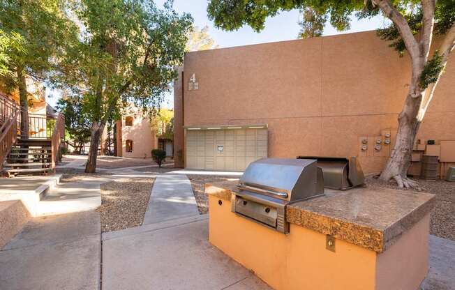 A tree is in front of a tan building with a garage door.