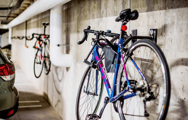 Underground parking lot at the modern apartment complex, featuring state-of-the-art electric vehicle chargers and bike racks for each assigned parking spot. A well-lit and spacious area with designated charging stations, ensuring convenience for residents with electric cars.