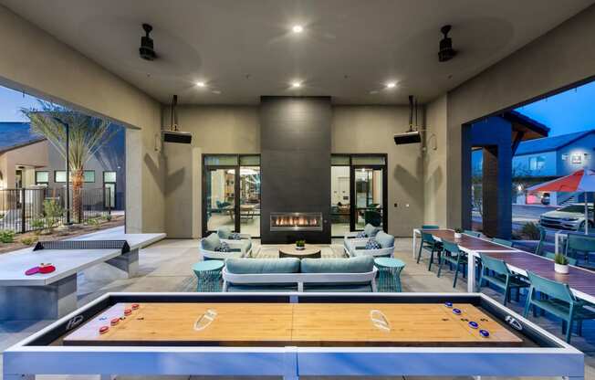 a clubhouse with a pool table and chairs and a fireplace