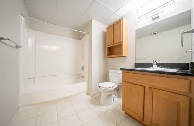 A bathroom with a toilet, sink, and bathtub.
