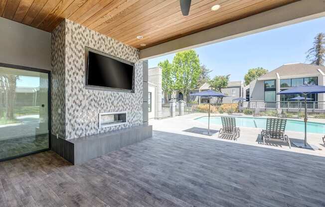 A modern house with a wooden ceiling and a television mounted on the wall.