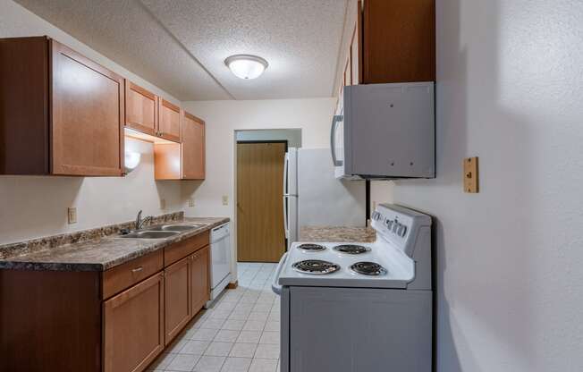 a kitchen with white tile flooring, white appliances at France, North Dakota