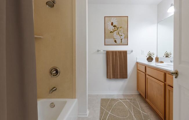 a bathroom with a shower and a sink and a mirror