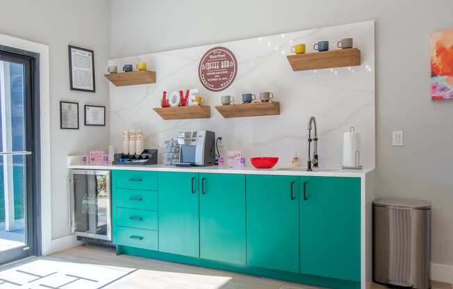 A coffee bar with a white marble wall and turquoise cabinets at Mandarin Bay Apartments.