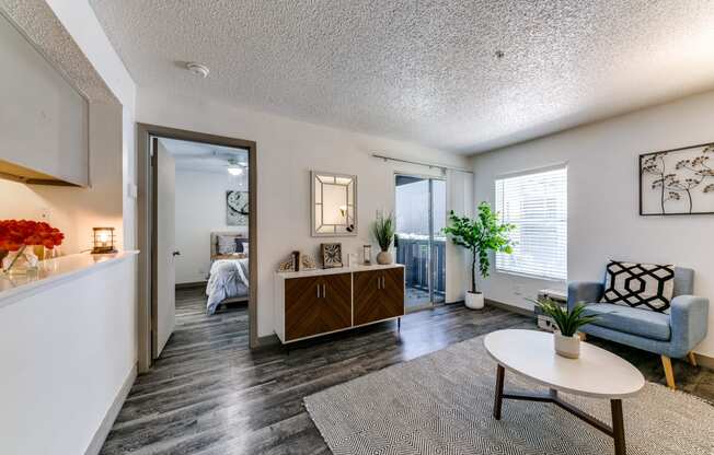 a living room with a couch and a table     and a bedroom