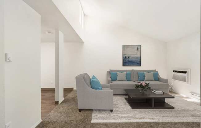 a living room with white walls and a brown rug at Park View Apartments, Wenatchee, WA