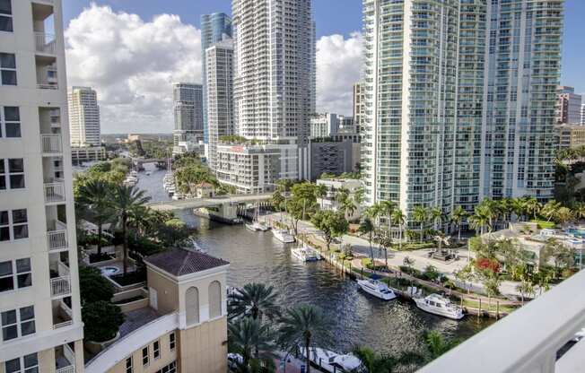 a view of the city from a balcony with boats in a river