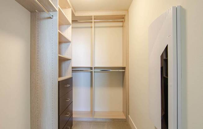 A white closet with a sliding door and a shelf.