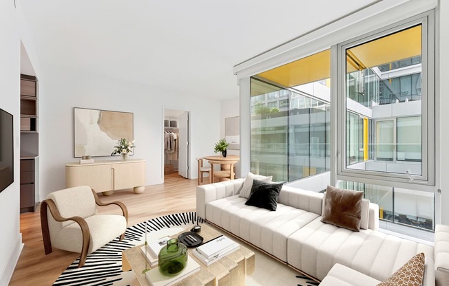 A living room with a white couch and a coffee table.