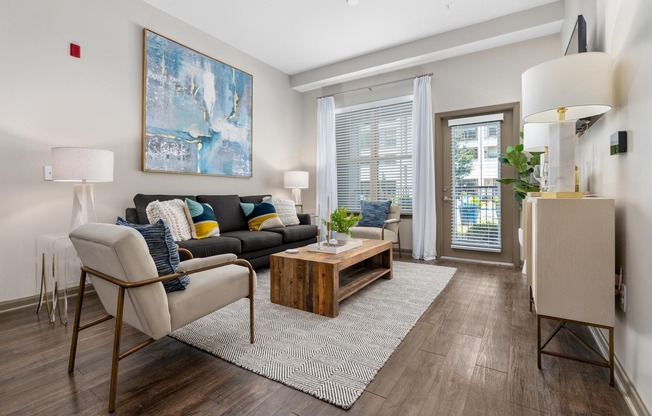 Open Living Room with Wood-Designed Flooring at Riverhouse Apartments in Little Rock, AR