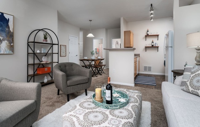 our apartments offer a living room with a couch a chair and a coffee table