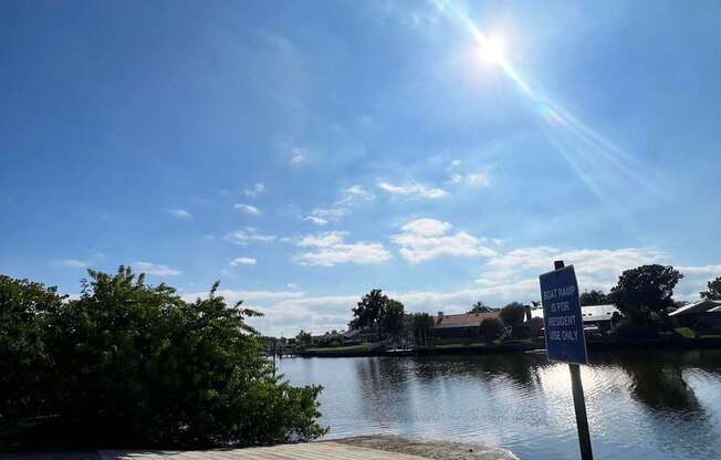 A sign on a post by the water reads "No swimming allowed.".