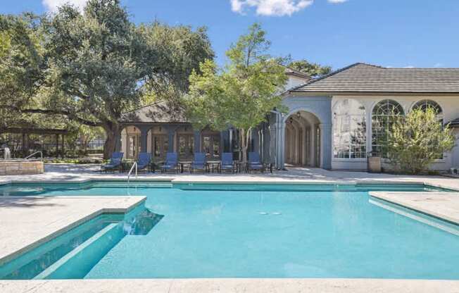 a swimming pool with a house in the background