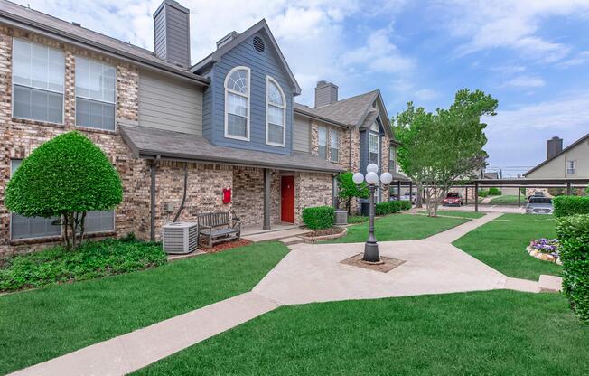 a large lawn in front of a brick building