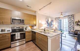 A modern kitchen with wooden cabinets and stainless steel appliances.
