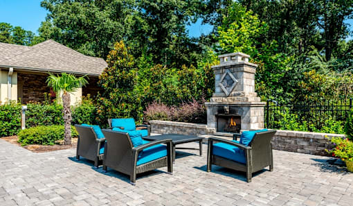 a patio with chairs and a table next to a fireplaceat Echo at Lake Norman, North Carolina, 28117