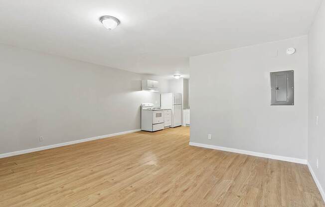 Element at 4411 Macon Apartments A room with wooden flooring and white walls, with a washing machine and dryer in the corner.