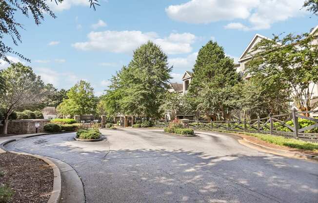 A residential street with houses on both sides and a sidewalk.