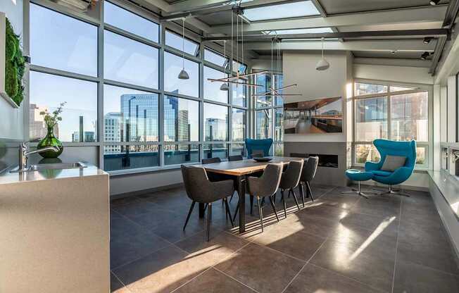 A modern dining room with a long table and chairs.
