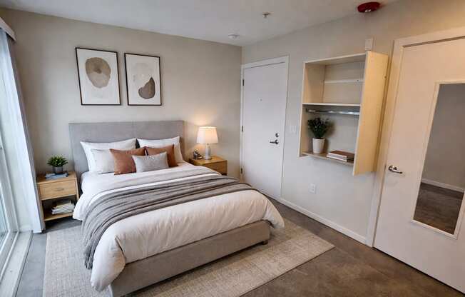 A bedroom with a large bed and a built-in closet.