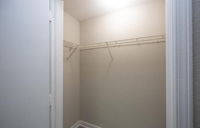 an empty closet in a small room with a white door at Magnolia Pointe Apartments in Duluth, GA