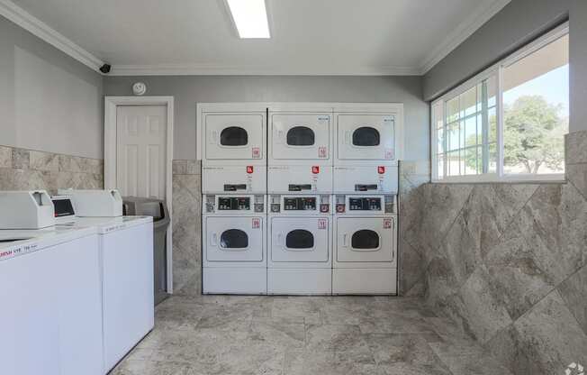 Laundry Center with Machines Next to Folding Counter at Dover Park Apartments, Fairfield, CA, 94533