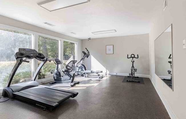 A spacious room with exercise equipment and a large window.