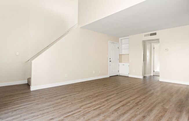 A room with wooden floors and white walls.