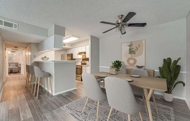 A dining room with a table and chairs.