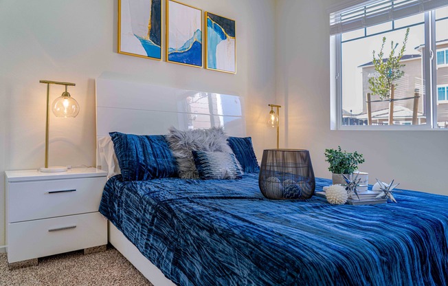 bedroom with carpeted flooring and bed with a blue comforter at Turtle Creek apartments