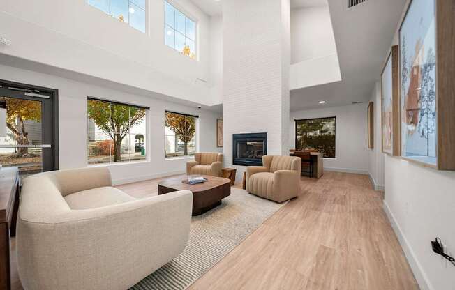 A modern living room with a large window and a fireplace.